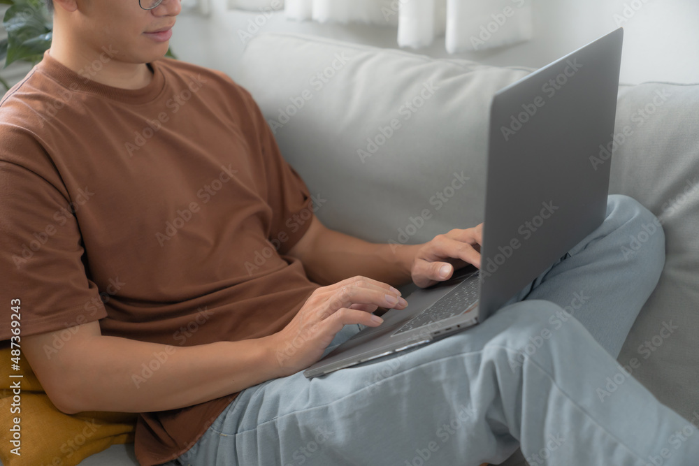 Work at home young asian man working on laptop computer while sitting at home Morning lifestyle Work at home young asian man working on laptop computer while sitting at home Morning lifestyle