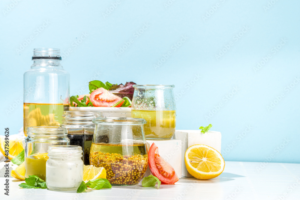 Fototapeta premium Variety of homemade salad dressings. Set of various salad sauces, oil, vinaigrette, mustard, mayonnaise, ranch, balsamic, soy, yogurt dressings