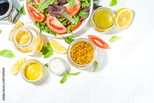 Variety of homemade salad dressings. Set of various salad sauces, oil, vinaigrette, mustard, mayonnaise, ranch, balsamic, soy, yogurt dressings