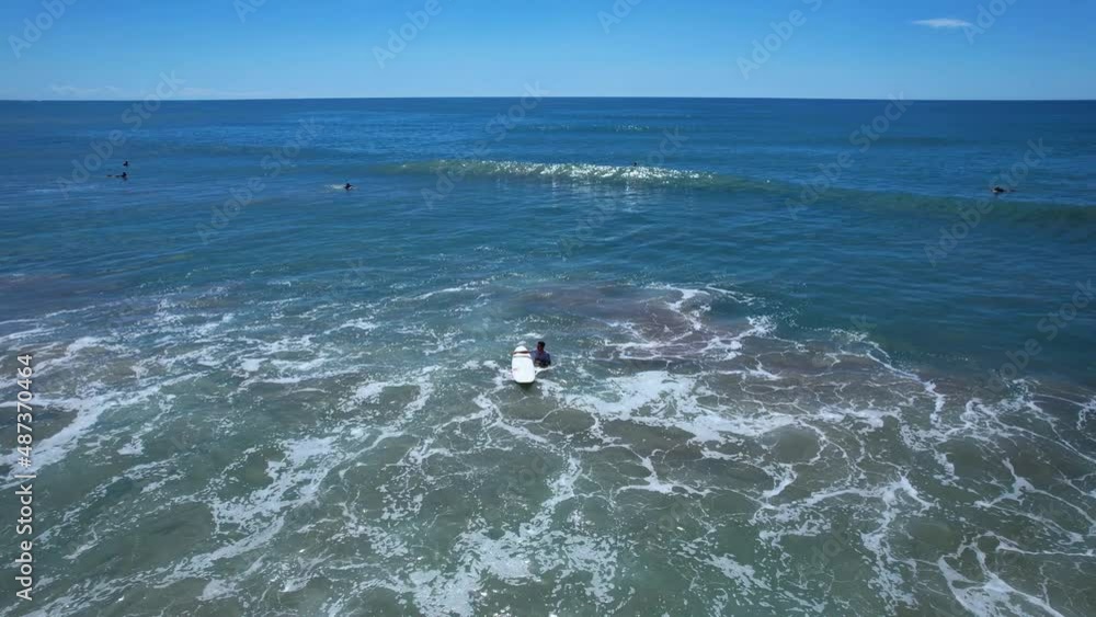 Surfer is waiting in the ocean in Santa Teresa Costa Rica Surfer is waiting in the ocean in Santa Teresa Costa Rica
