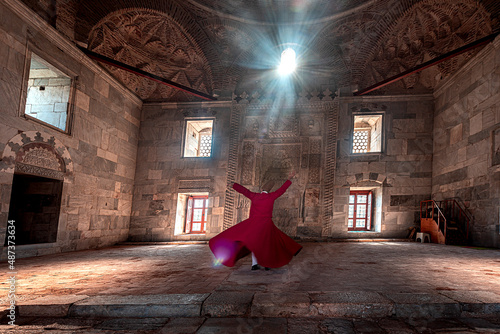 02.04.2022,Soke,Aydin,Turkey,whirling dervish performing in red costume and hat photo