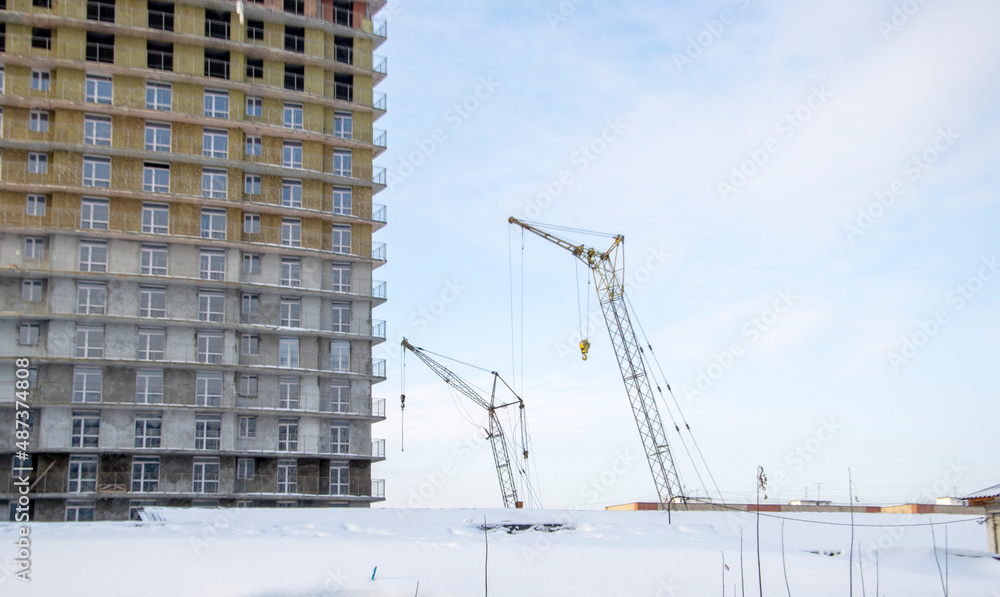 Tower cranes near a high-rise building under construction Tower cranes near a high-rise building under construction
