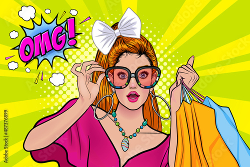 Surprised woman with glasses holding shopping bags
