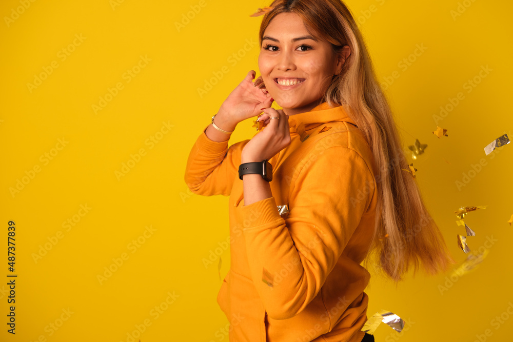A woman in yellow clothes rejoices in a holiday A woman in yellow clothes rejoices in a holiday