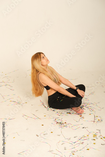 A woman sits in a confitti