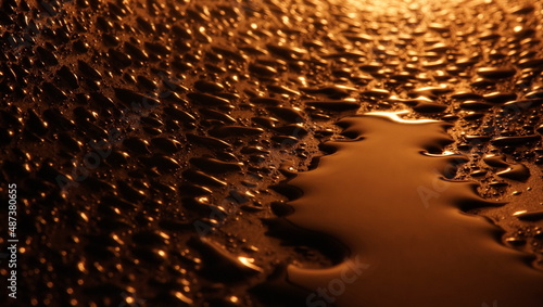 Water drops on uneven surface brown chocolate light background selective focus