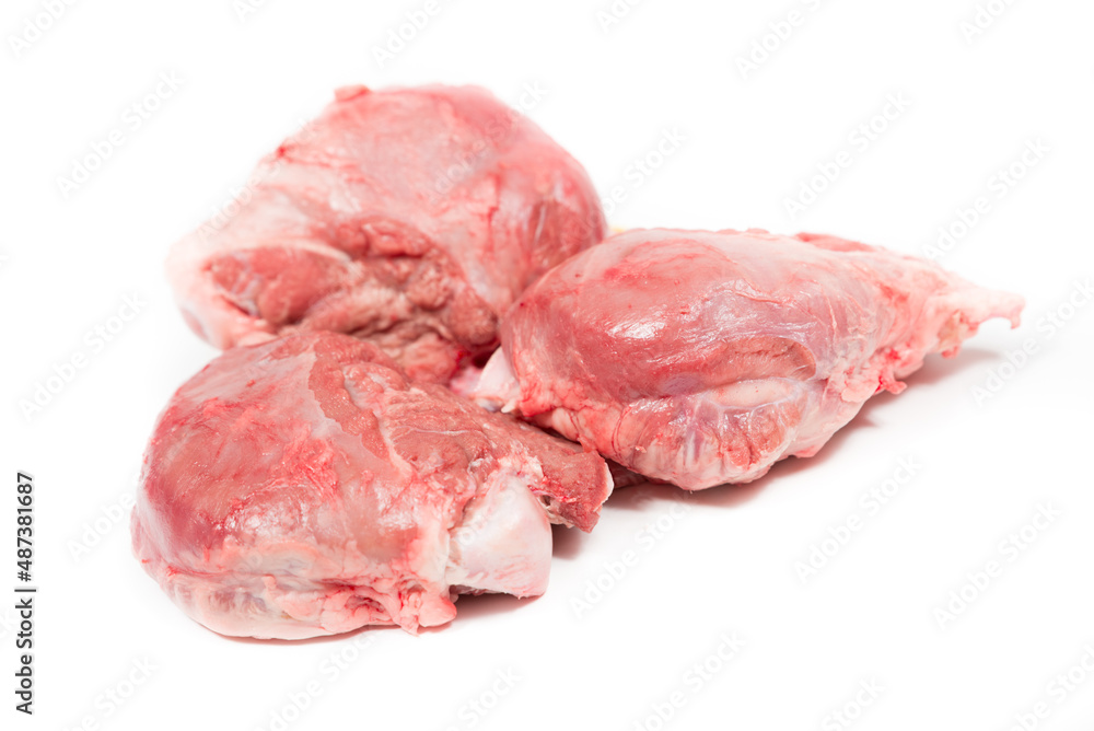 Three pig cheeks raw pieces in a white background