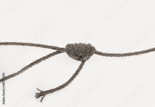 Rope knot on light gray background.