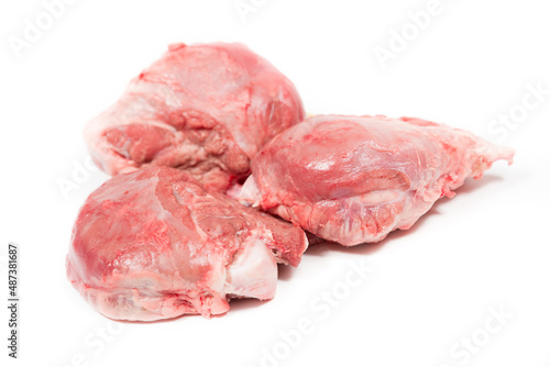 Three pig cheeks raw pieces in a white background