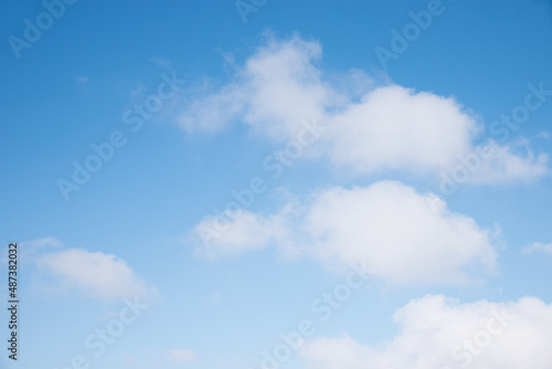 gradient blue sky background with soft cumulus clouds