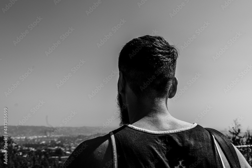 silhouette of a person staring out at los angeles skyling