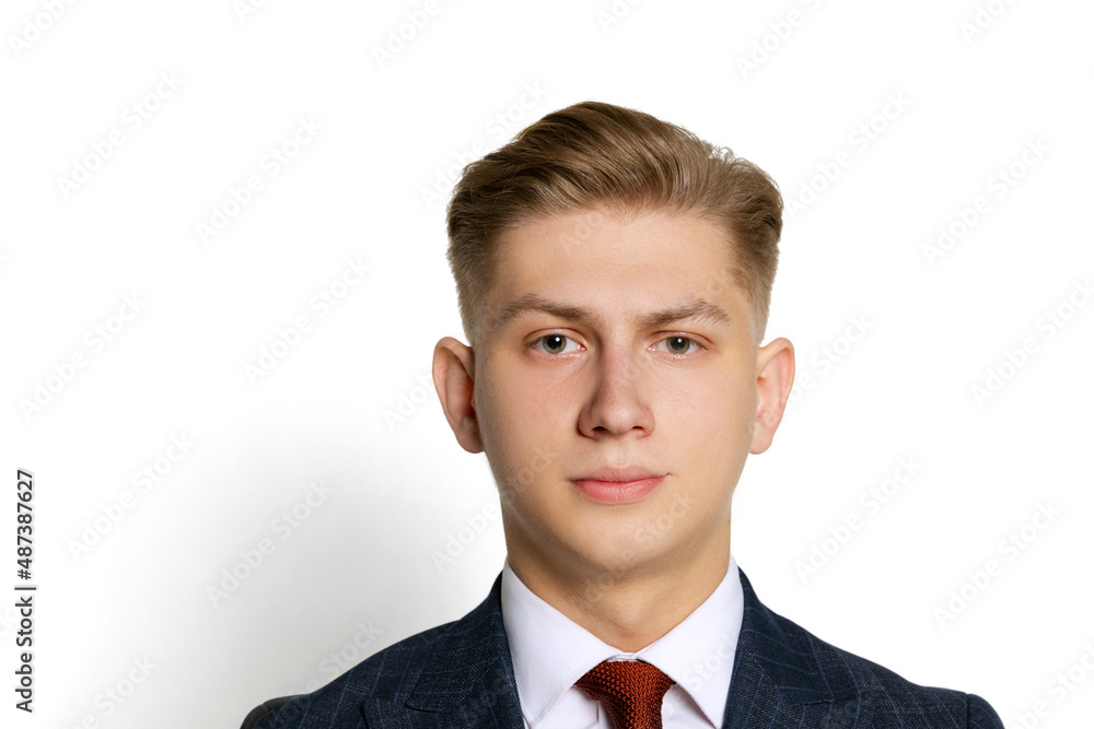 Close-up portrait of handsome young businessman, student, diplomat looking at camera isolated on white studio background. Human emotions, facial expression concept. Close-up portrait of handsome young businessman, student, diplomat looking at camera isolated on white studio background. Human emotions, facial expression concept.