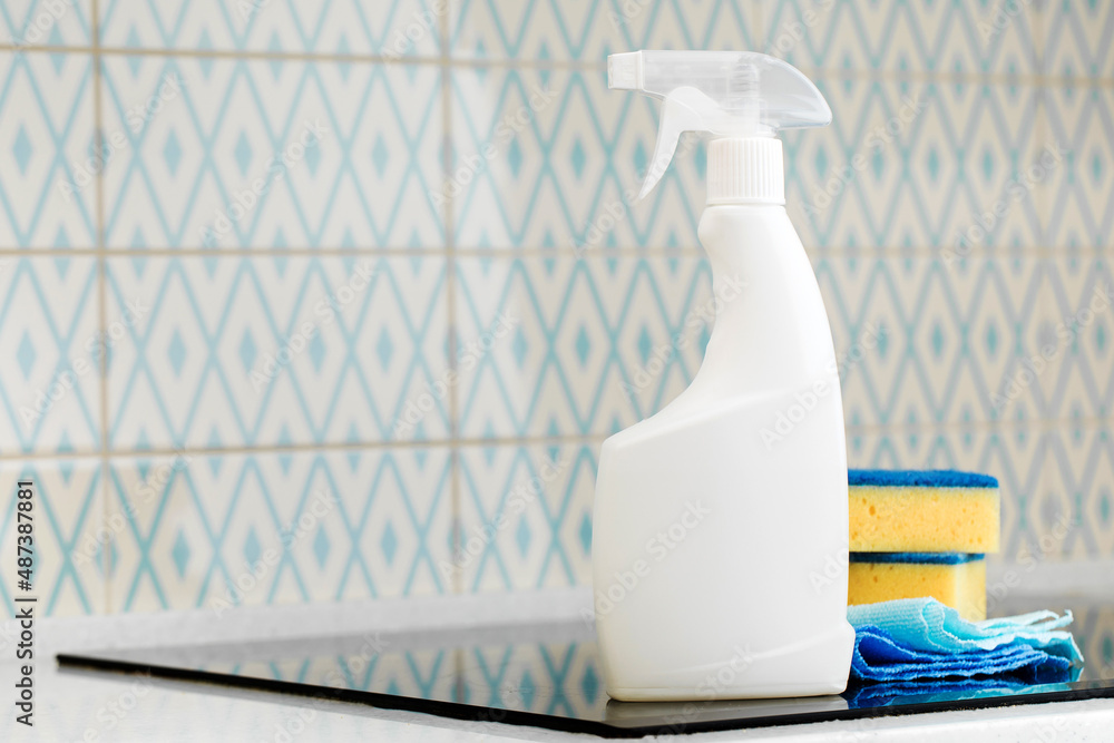 Mockup of a white spray bottle with a stovetop cleaner. General