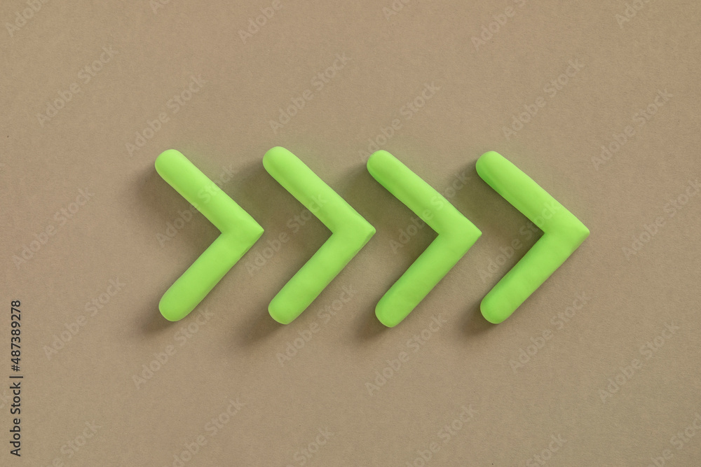 Green arrows pointing right side. Three dimensional arrow sign showing direction on neutral background. Development concept, go green or heading target metaphor, striving for the goal, going forward.