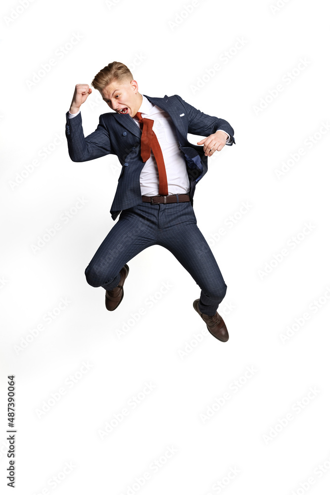 Excited young businessman, student, diplomat jumping isolated on white studio background. Human emotions, facial expression concept.
