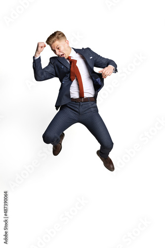 Excited young businessman, student, diplomat jumping isolated on white studio background. Human emotions, facial expression concept.