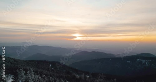 snowy mountain at sunset drone forest trees in germany
