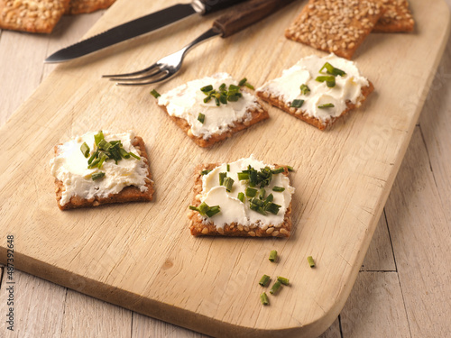 Sesame crackers with cream cheese and chives