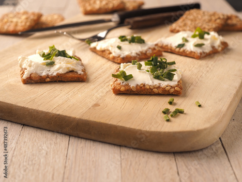 Sesame crackers with cream cheese and chives