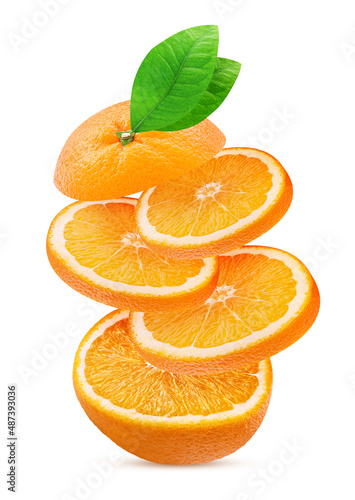 Orange fruit slice with green leaf flying in the air