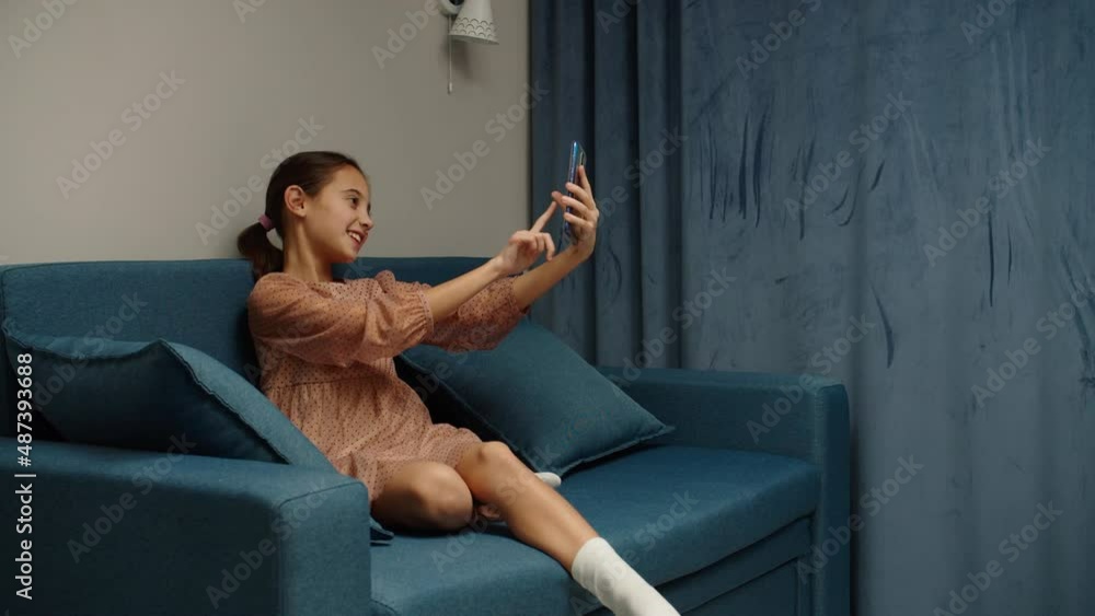 Charming preteen girl taking selfie, using mobile phone, photo ...