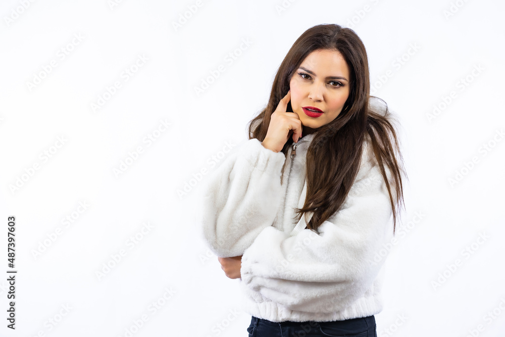 Latin woman with black hair and a white wool sweater photographed in a studio with a white background Latin woman with black hair and a white wool sweater photographed in a studio with a white background