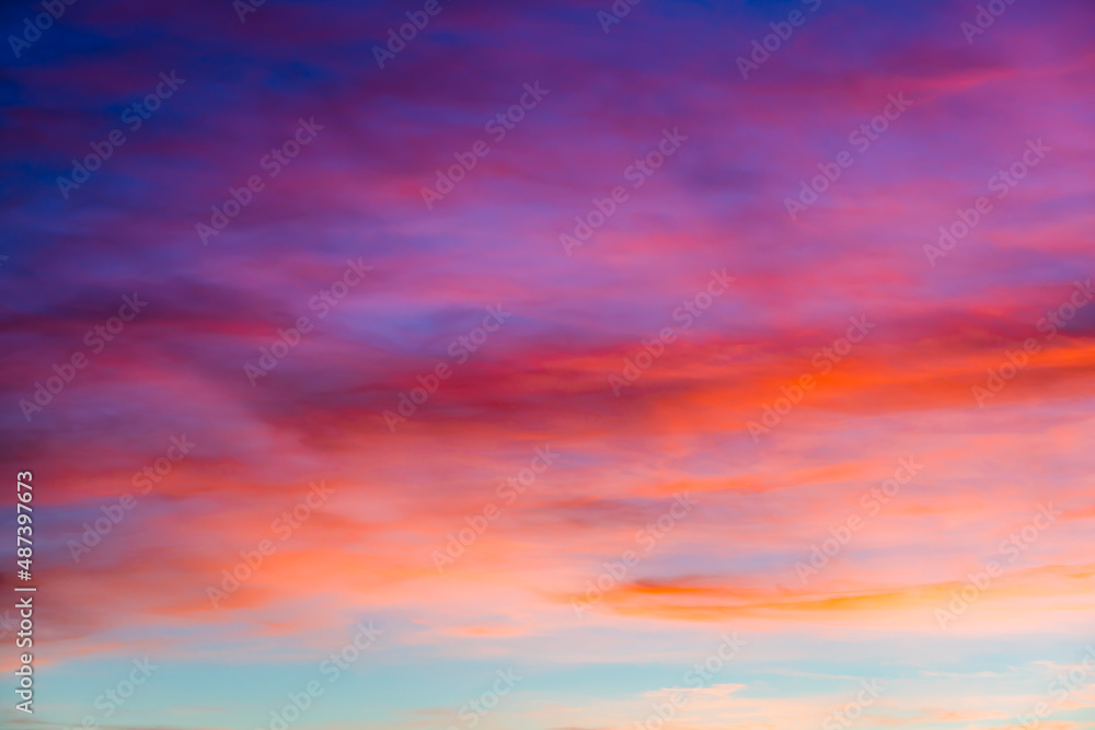 Sunset sky with red orange and blue gradient clouds