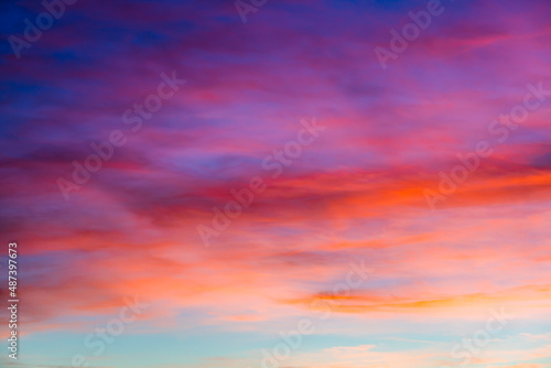 Sunset sky with red orange and blue gradient clouds