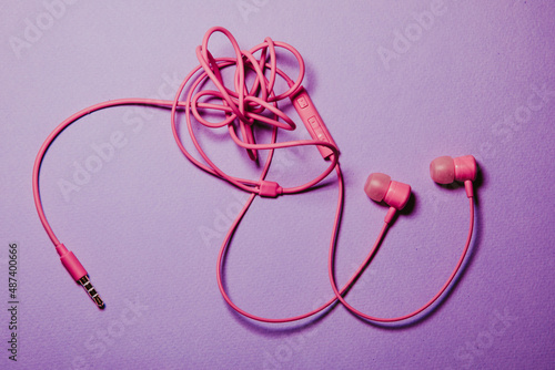 colored tangled headphones on a lilac background