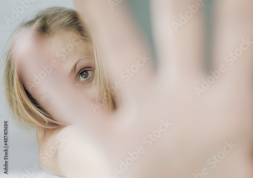 Woman eye look from blureed hand fingers photo
