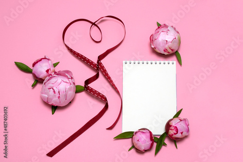 on a pink background a white leaf, beautiful pink peonies, a heart made from a red ribbon. card, congratulations on March 8, Valentine's Day, Mother's Day