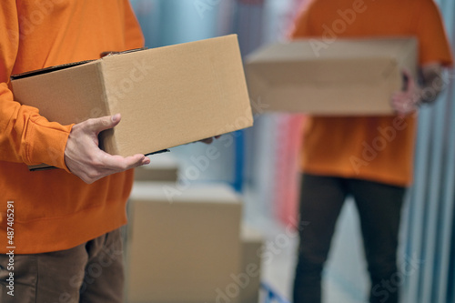 Male workers unloading goods in the warehouse