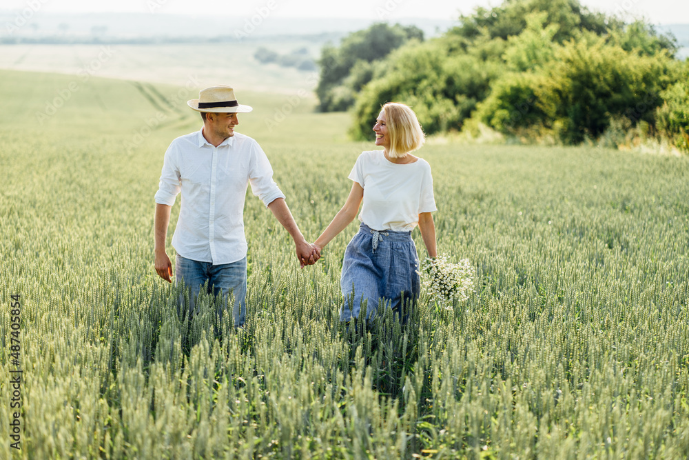 Summer Lifestyle. Love story outdoor in spring field. Loving couple talking laughing and walking. Summer Lifestyle. Love story outdoor in spring field. Loving couple talking laughing and walking.