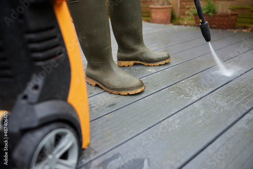Close Up Of Man Jet Washing Patio Decking With Pressure Washer © Daisy Daisy