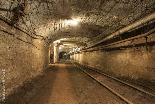 Narrow gauge railroad in the underground mine horizon. Technologies of mining of minerals by the underground method. Underground mine for mining ore