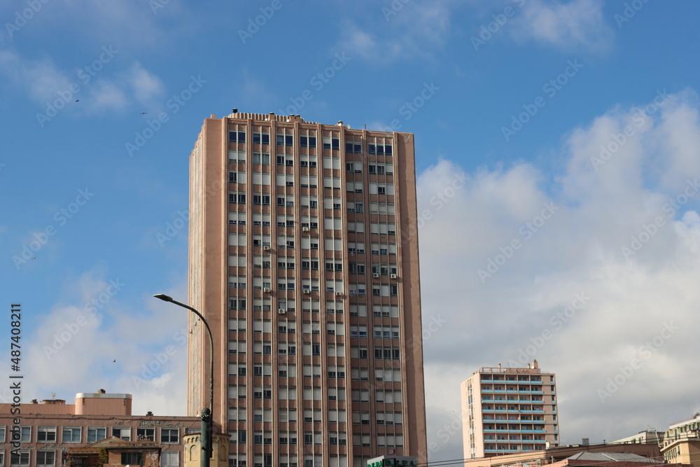 Genova, Italy - January 29, 2022: Beautiful modern high-rise buildings against the sky. 3d illustration on the theme of business success and technology. clouds reflection on the mirror.