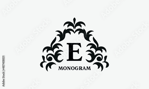 Elegant floral logo design template for letter E. Calligraphic dark elegant ornament on white background. Business sign, identity monogram for restaurant, boutique, hotel, heraldic, jewelry.