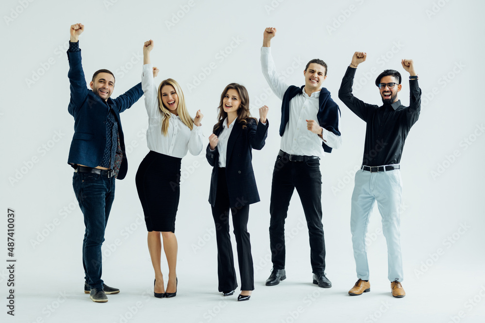 Obraz premium Happy business group. Young business team celebrating victory isolated on white background