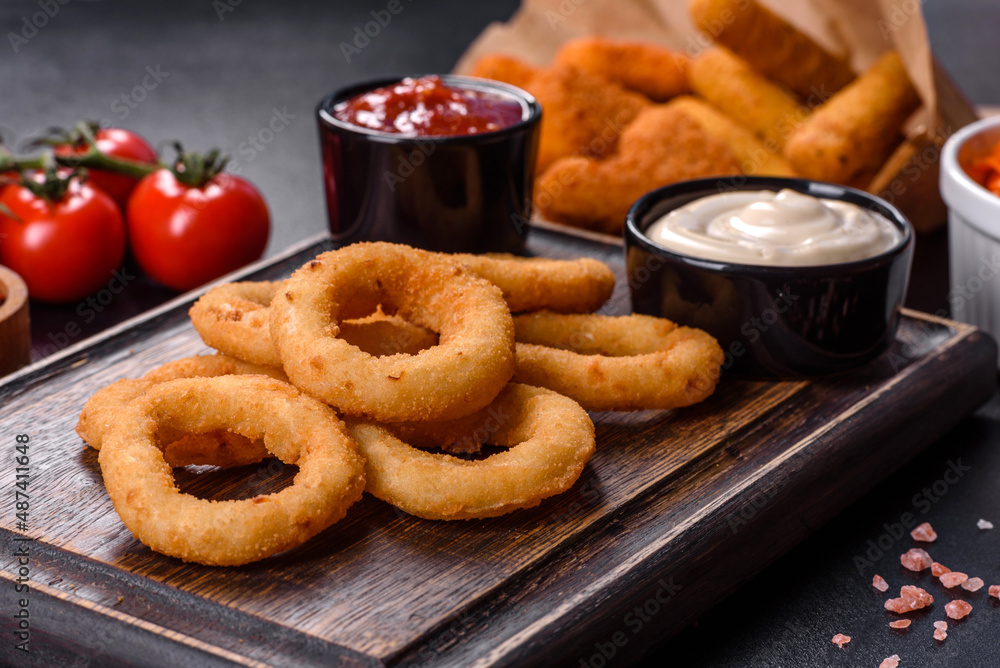 Homemade crunchy fried onion rings with tomato sauce Homemade crunchy fried onion rings with tomato sauce