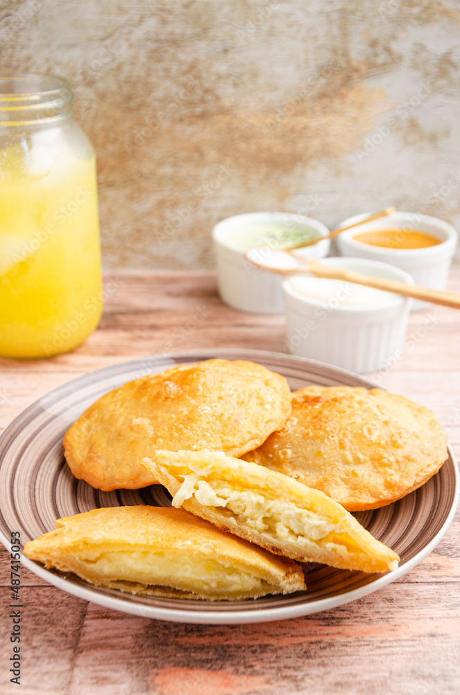 Traditional Venezuelan food with guasacas and orange juice. Rustic and wooden background Traditional Venezuelan food with guasacas and orange juice. Rustic and wooden background