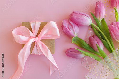 Fototapeta Naklejka Na Ścianę i Meble -  Happy womens day. 8 march. Pink tulips bouquet and gift box on pink background flat lay. Happy Mothers day. Greeting card. Gentle image