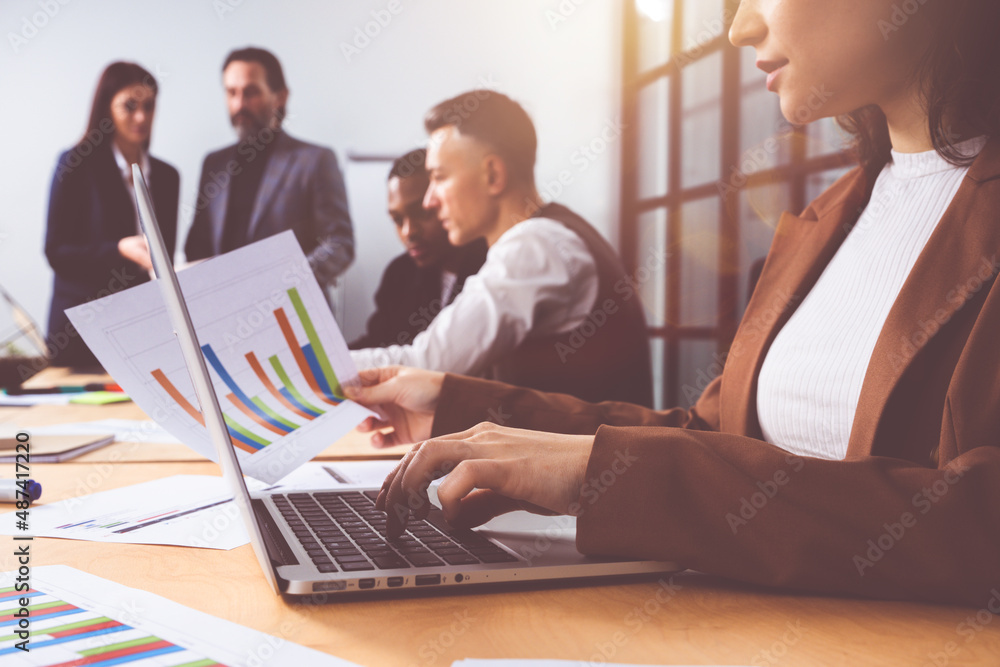 Group of business people have a meeting about company stats Group of business people have a meeting about company stats