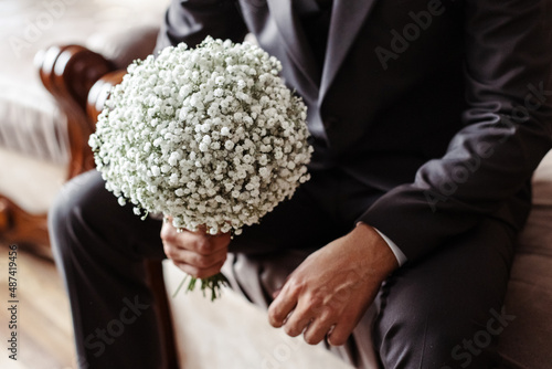 A man holds a wedding bouquet. photo