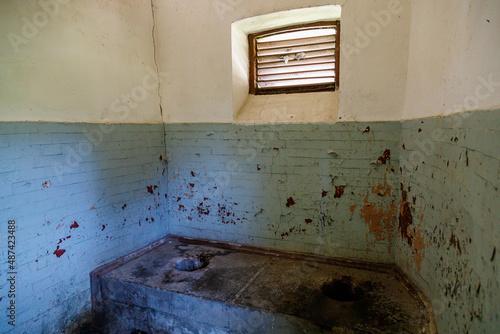 An old outdoor toilet building with a hole in the floor in a third world country. Background with copy space photo