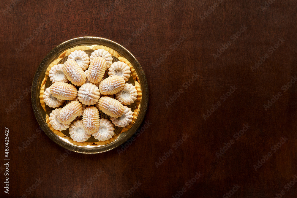 Assorted semolina maamoul or mamoul cookies with dates , walnuts and pistachio nuts. Traditional middle eastern sweets . Top view, copy space Assorted semolina maamoul or mamoul cookies with dates , walnuts and pistachio nuts. Traditional middle eastern sweets . Top view, copy space