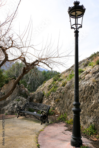 Vintage lamppost and iron bench in Guadalest village photo