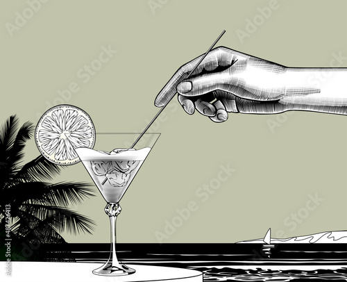 Engraved vintage drawing of a female hand holding a straw dipped in a cocktail with a orange slice