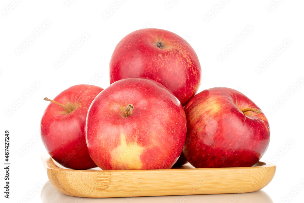 A few sweet organic, red apples on a bamboo tray, macro, isolated on a white background.
A few sweet organic, red apples on a bamboo tray, macro, isolated on a white background.