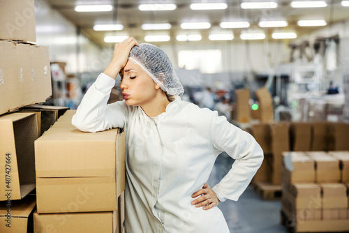 A food factory worker having troubles at work. photo