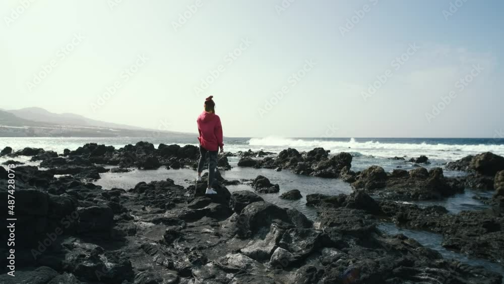 woman enjoying the ocean on volcanic beach of the Canary island of Tenerife. Beautiful landscapes in the north of Tenerife island
woman enjoying the ocean on volcanic beach of the Canary island of Tenerife. Beautiful landscapes in the north of Tenerife island